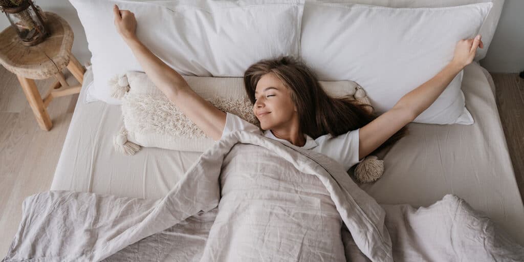 woman waking up rested in bed