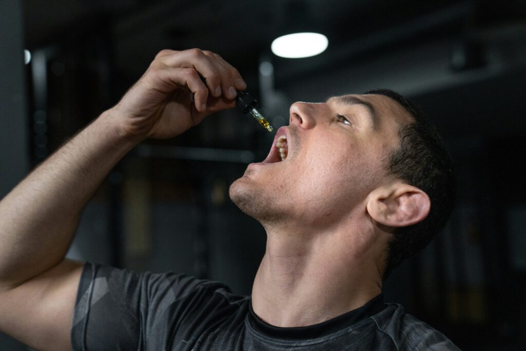 Man applying cannabis oil orally