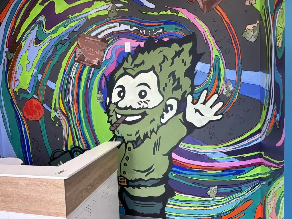 Mural of a gnome smoking a joint in front of colorful swirls